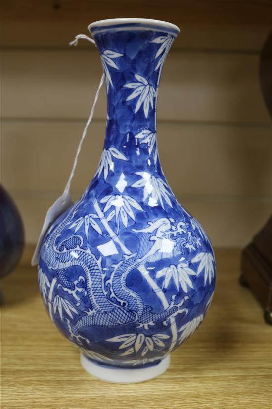 A Chinese blue and white dragon vase and a flambe vase tallest 22.5cm